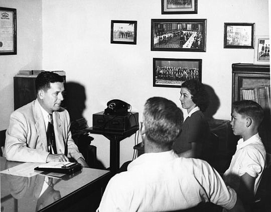 Superintendent Arthur Dozier meeting with student and parents at the school. (Photo from floridamemory,com)