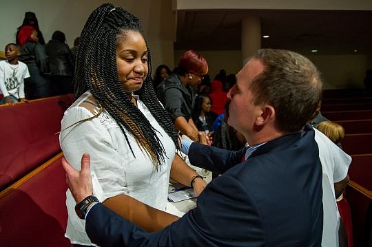 Mayor Lenny Curry talks with Tomeshia Brown, mother of Aiden McClendon, at the end of a prayer vigil last Monday at Bethel Baptist Institutional Church. Aiden was murdered in a Jan. 29 drive-by shooting, as he sat in a car with Brown and his grandmother.