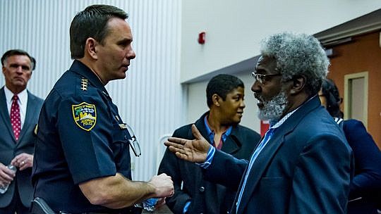 Jacksonville Sheriff Mike Williams talks with Ken Covington at the close of Thursday's community conversation on youth crime.