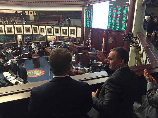 Mayor Lenny Curry starts to high-five JAX Chamber President Daniel Davis immediately after the House overwhelmingly approved a bill  Wednesday to extend a Jacksonville half-cent sales tax to help pay down the city's $2.7 billion pension liabilities.