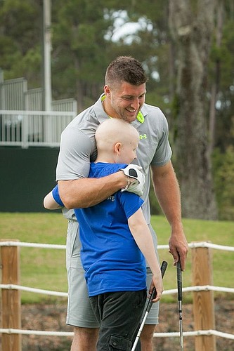 Tim Tebow hugs a child during a previous fundraiser.