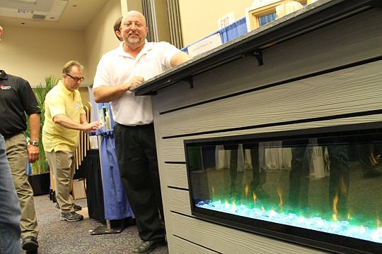 David Klotz of Construction Solutions and Supply showed an electric fireplace at the Northeast Florida Builders Association's annual Trade Expo.