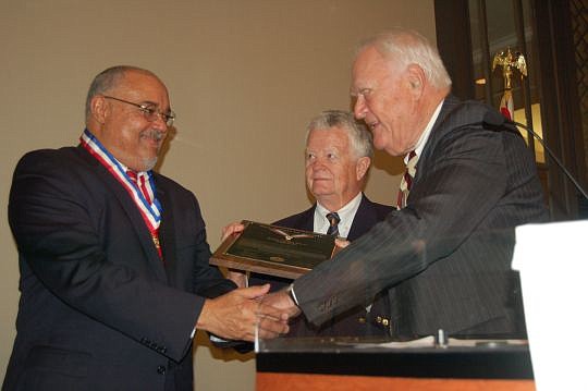 From left, U.S. District Judge Brian Davis receives the Distinguished Eagle Scout Award from Bill McCamy, chair of the North Florida Council Boy Scouts of America Eagle Scout Association Committee and 11th Circuit Court of Appeals Judge Gerald Tjoflat.