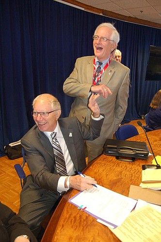 There was a short but spirited celebration, including a high-five with City Council member Bill Gulliford, standing, on Tuesday when JEA board Chair Tom Petway signed the new interlocal agreement between the utility and the city. Gulliford led a commi...