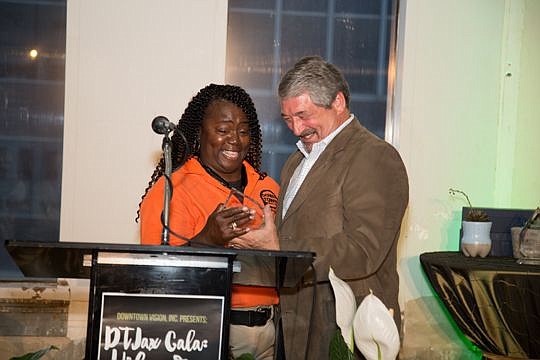 Lydia Cobbert received the Downtown Ambassador of the Year award from Jim Bailey, publisher of the Daily Record and chair of the Downtown Investment Authority board of directors.
