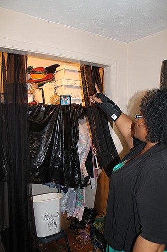 Robin Harris points to her closet, one of five places in her home damaged by a leaky roof. In three years she's hired two different contractors to fix it. They took the money and her roof still leaked.