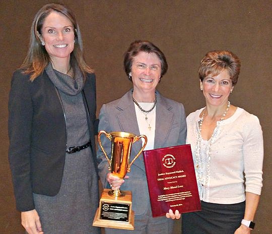 Mary Bland Love, center, received the 2016 Justice Raymond Ehrlich Award from Melissa Nelson, chair of The Jacksonville Bar Association Litigation Section, and JBA President Giselle Carson.