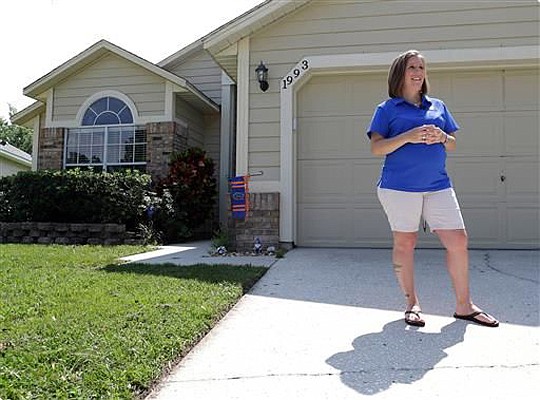 Michelle Harner stands in front of her house in the Piedmont Park neighborhood in Apopka. She has seen a surge of renters in the past decade.