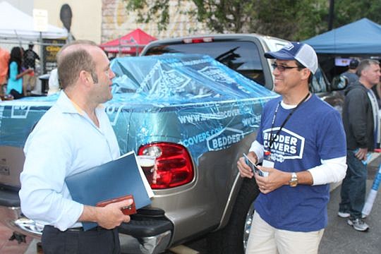 Michael DelCharco talks to a customer Wednesday evening who stopped by to check out his Bedder Covers product. The truck-designed product received validation at last year's One Spark and was on sale for patrons this year.