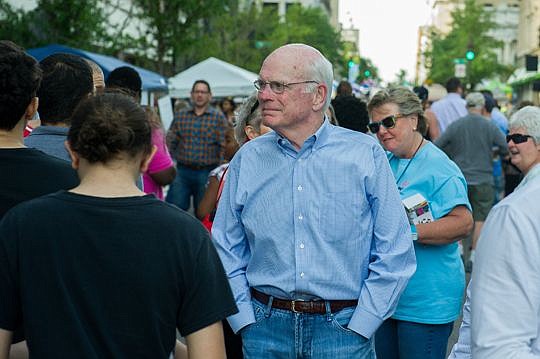 Peter Rummell walks down Laura Street on Wednesday during the retooled One Spark crowdfunding festival.