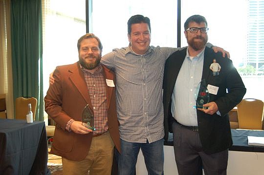 Staramba USA partners Adam Dukes, left, and Bryce Pfanenstiel, right, with Jim Brisimitzis, general manager of Microsoft USA's Startup Program, after Thursday's Spark Tank.