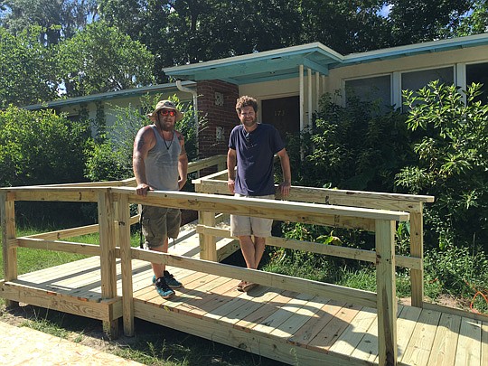 Adding a wheelchair ramp to a home is not a particularly big or dramatic change to a structure, but it has a large impact on the people who need to enter and exit their homes. Standing on a newly completed ramp are Michael Trapnell, left, of Southern ...