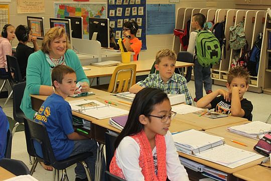 Florida Blue Duval County Teacher of the Year Kay Park of Alimacani Elementary sits among her third-graders to listen to a student presentation. Park is big on students sharing their work with others, which helps them take ownership of the work while ...