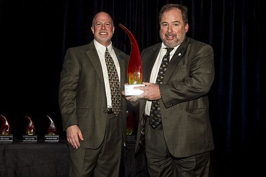 MacKenzie, right, with his award and Jim Kowalski, executive director of Jacksonville Area Legal Aid.