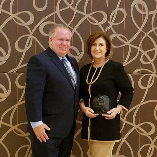 Northwest Federal Credit Union Indirect Loan Officer Duane Daski presented the Florida Literacy Coalition's Excellence in Education Award to Judy Bradshaw, executive director of Learn to Read,