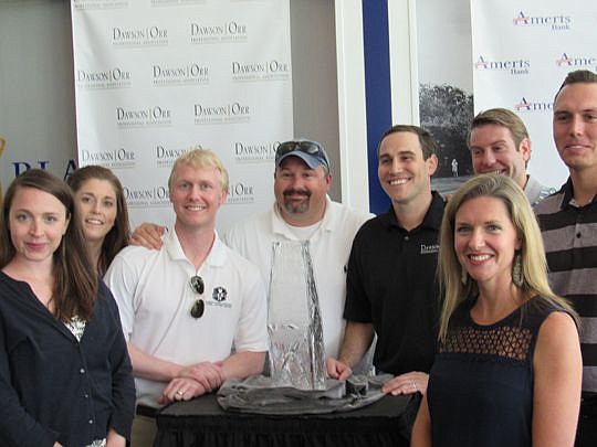 Attorneys from Dawson Orr with the Championship Trophy: from left, Katie Crowley, Jessica Creegan, Jeremy Paul, Giovanni Stewart, Michael Fox Orr, Amanda Ferrelle, John Leonard and Taylor Jarman