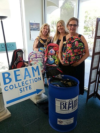 From left, Realtors Carol Burns, Lauren Spiller and Clare Berry with some of the donations for the Back to School with BEAM project.