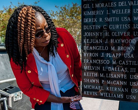 Vanessa Williams sees her husband's name engraved on the Veterans Memorial Wall in Jacksonville for the first time Monday. His name was among five added to the memorial.