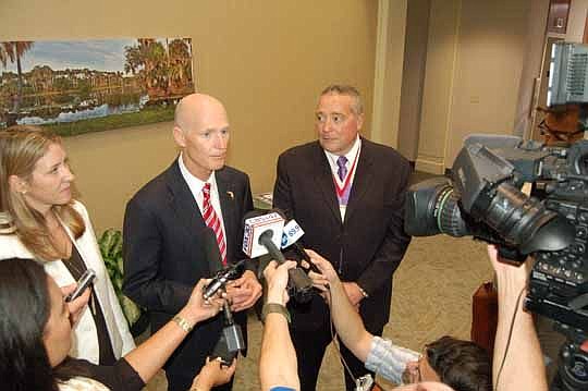 Gov. Rick Scott, left, and Terry Terhark, founder and CEO of randrr, a job search mobile app in development, announced Wednesday the Ohio-based company's expansion in Jacksonville.