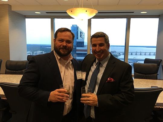 Charles Jimerson, right, and Robert Heekin Jr., demonstrating that opposing counsel can enjoy a beverage and some collegiality.