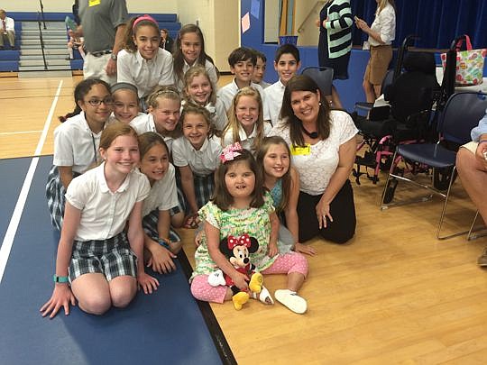 Eight-year-old Caroline Abbott, front right, is shown with students at Palmer Catholic Academy in Ponte Vedra. Children at the school raised $1,500 for Caroline's Disney Dream in March. It's the second year Palmer Academy has been part of the Dreams C...