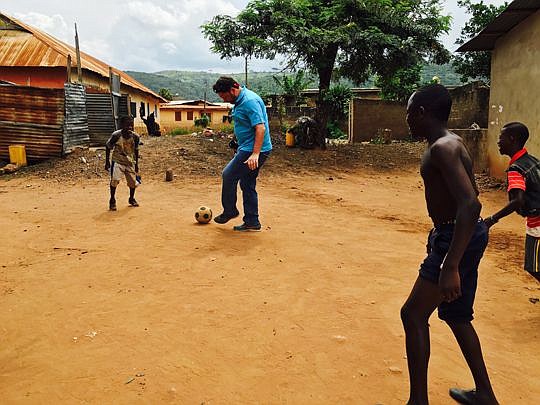 John Phillips plays soccer with children in Ghana during his visit to PeaceJam conference last month. The Jacksonville attorney soon found out the boys were a lot better at the game than he is.