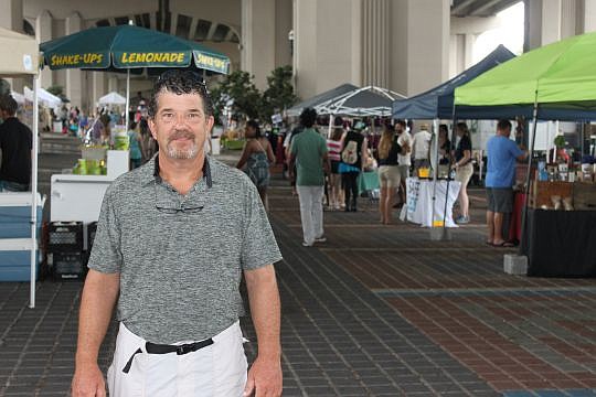 John Silveira needed his rain jacket Saturday, his first event as Riverside Arts Market's senior manager. He spent a post-U.S. Navy career in the West Coast market business but recently was hired to run the weekend mainstay under the Fuller Warren Bri...