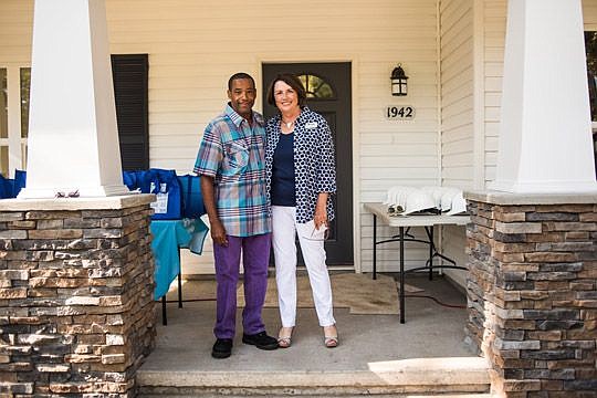 Mary Kay O'Rourke, executive director of HabiJax, congratulated Andre'a Raysor for his family becoming the 2,000th to be served by the local affiliate of Habitat for Humanity International.
