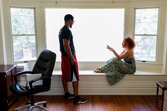 Maurice Fordham and April Robinson check out the large picture window and seat in what would be the master bedroom at the former Henrichsen Siegel law offices at 1648 Osceola St. in Riverside.