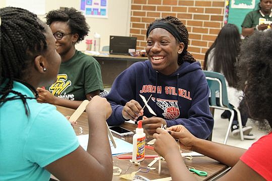 Ed White High School student Alexis Evans builds rubber-band helicopters with her classmates at the Communities In Schools of Jacksonville summer STEM camp.