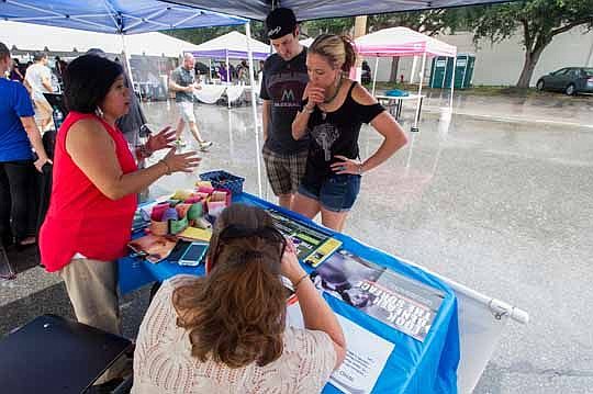 Northeast Florida Human Trafficking Coalition ambassadors Silvia Almond, left, and Robin Rossmanith chat about the organization's objectives with Emily Ruse and Jordan Beard.