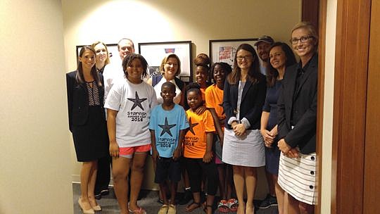 Students Kiya Evans, 14; Earnest Walker, 12; Zion Bell, 11; Janiya Trotter, 7; and Tabitha Hill, 13, pose in front of their art with U.S. Magistrate Judge Patricia Barksdale, U.S. District Judges Marcia Morales Howard and Timothy Corrigan; law clerk L...