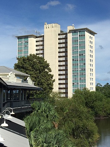 A view of the 16-story Commander Apartments in Avondale from the back deck of the St. Johns Village retail and business center. Chance Partners proposes to redevelop the property, including demolishing the retail center to build more apartments.