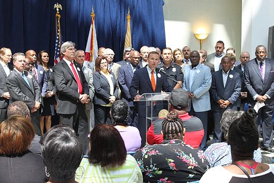 Mayor Lenny Curry is surrounded by business, religious, cultural and elected leaders from across the city Monday to show support for the sales-tax referendum to pay down pension obligations. The measure is on the Aug. 30 ballot.