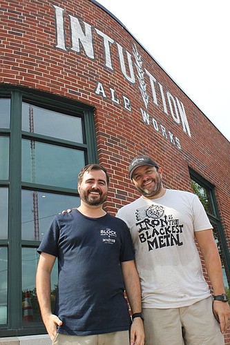 Intuition Ale Works brewer and founder Ben Davis, right, and tap room manager Riley Leuthhold outside what is Downtown's latest beer destination. Intuition's tap room at Bay Street and A. Philip Randolph Boulevard opens today.