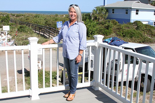 Cora Johnston stands on the deck of a south St. Augustine Beach house remodeled by her company, Generation Homes.