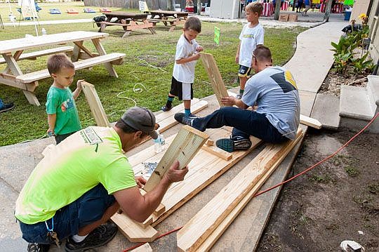 Holland &amp; Knight family members of all ages turned out for the annual National Day of Service and Remembrance to honor Sept. 11 victims. Glenn Winuk, a partner in the firm's New York office, died during the terrorist attacks. Above, Tony Morgan, u...