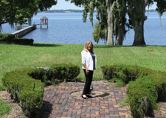 Anita Vining of Berkshire Hathaway HomeServices Florida Network Realty at a St. Johns River property home in the San Jose area of Jacksonville that she has listed.