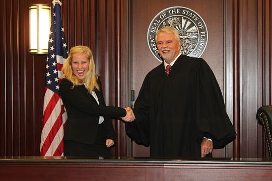 Mary Heckler couldn't hide her excitement on her swearing-in day and for shaking hands with 4th Judicial Circuit Chief Judge Mark Mahon following the ceremony Thursday. Heckler graduated from Stetson College of Law.