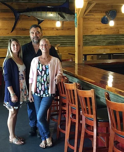 Kayla Smith, Mike Parsons and Cindy Parsons at their Parsons Seafood Restaurant that opens Friday in Neptune Beach.