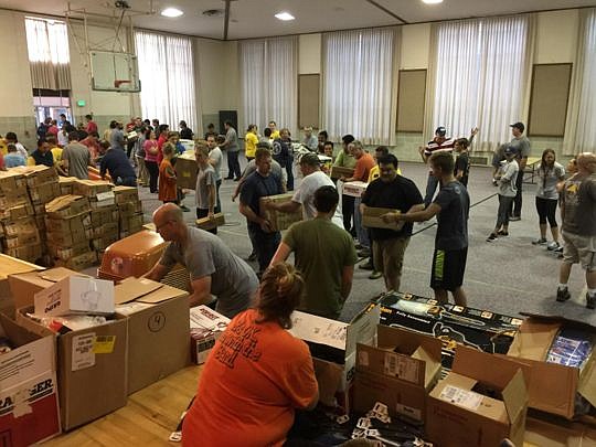 Volunteers from Mormon Helping Hands unload one of several supply trucks that arrived in Jacksonville from LDS Emergency Services.