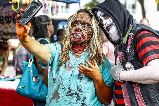 Tiffany Valdivia and Jeremy Spicer pose for a zombie selfie at the Jacksonville Zombiefest at Hemming Park on Saturday.
