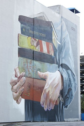 Downtown's streetscape began an artistic renovation after the first Art (Re)Public mural project was completed this week. The mural at 25 W. Forsyth St. is of a person carrying a stack of books. It was inspired by international artist Case Maclaim's v...