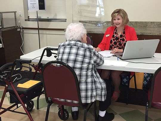 Attorney Vicki Bowers assists a resident of Pablo Towers in Jacksonville Beach during the Advance Directives for Seniors Project.