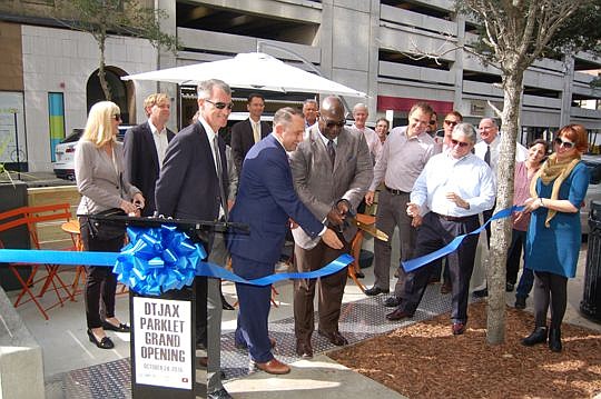 Downtown Investment Authority CEO Aundra Wallace cut the ribbon Monday morning to open Jacksonville's first parklet. He was joined by Downtown Vision Inc. CEO Jake Gordon, DVI board members, project consultants and other supporters. The parking space ...