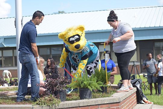 United Way of Northeast Florida volunteers and Jacksonville Jaguars mascot Jaxson de Ville helped beautify S.P. Livingston Elementary School in New Town as part of the annual Hometown Huddle service event.