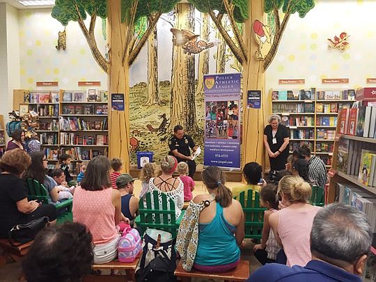 Sheriff Mike Williams read to children at the St. Johns Town Center Barnes &amp; Noble store to kick off the holiday book drive, which runs through the end of December to benefit the Police Athletic League of Jacksonville.