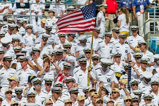 The red, white and blue proudly flew among a sea of dress whites of the Naval Academy Midshipmen on Saturday afternoon.