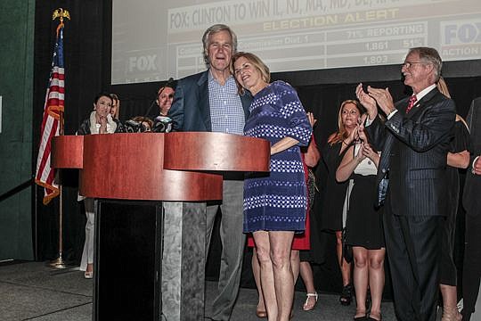 U.S. Rep. Ander Crenshaw, R-Fla., hugs his wife, Kitty, at the Republican Party of Duval County's celebration Tuesday night at the Hyatt Regency Jacksonville Riverfront. At right is John Rutherford, who is replacing Crenshaw in Congress, who is retiring.