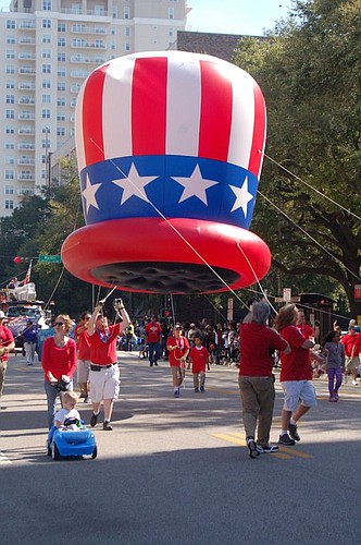 It wasn't quite the Macy's Thanksgiving Day Parade, but the red, white and blue top hat balloon was a hit with people who lined the sidewalks along the route.